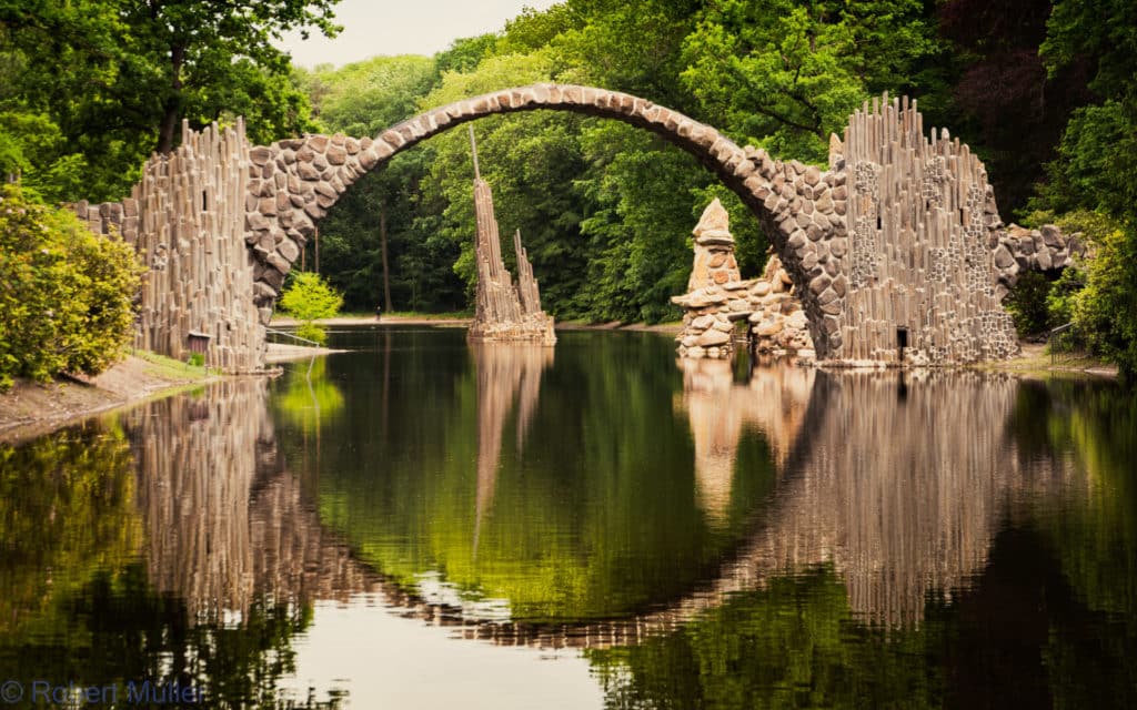 Die Teufelsbrücke (Rakotzbrücke) spiegelt sich im Wasser des Rakotzsees.
